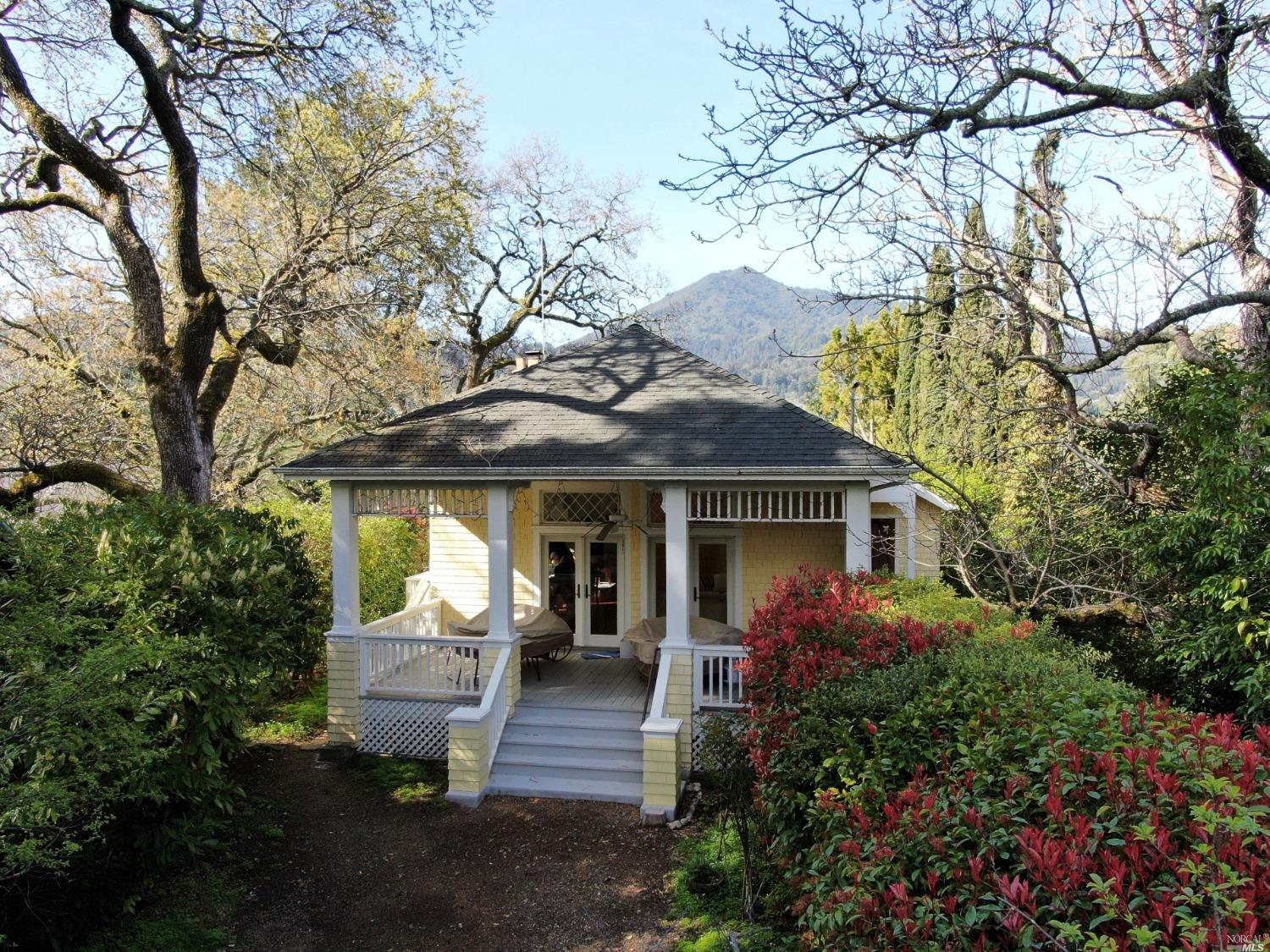 Vintage Charmer in the prime heart of Kentfield Gardens. Set back from the street with the driveway entrance on Rosebank Avenue, this magical home is ideally sited on a flat, gated, street-to-street two parcel lot with stunning views of Mt. Tamalpais. Expanded over the years with vaulted LR ceilings and  skylights that fill the room with natural light. The living room opens through double French doors to a mature yard and garden blooming with roses and azaleas. Kitchen with gas cook top and ample cabinetry, counter space and breakfast bar. Two bedrooms both with views over the west facing porch to Mt.Tamalpais beyond. Two full bathrooms plus a full height basement, workshop and storage. Ample off-street parking. Kentfield School district with an easy location where kids can get to both Bacich Elementary and Kent Middle School.  In a neighborhood of higher priced homes, this is a special opportunity you won't want to miss.