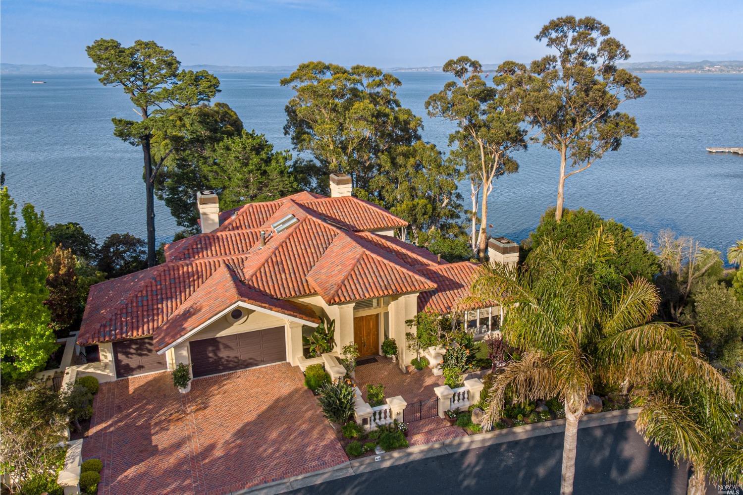 As you enter 44 Marin Bay Court, be carried away to the finest seaside European Villa! Breathtaking bayfront vistas surrounded by gardens and natural habitat are the private setting for the 5 bedroom, 5 bath 5560 square foot residence. Fine building and sense of scale are seen in the soaring ceilings, wonderful natural light, deep moldings, elegant hardwoods and marble floors. The current owner has enhanced the home with custom design elements inside and out: curated lighting, remodeled kitchen, custom window coverings, hot tub, fire pit, outdoor BBQ, the list goes on. The main level is ideal for entertaining, featuring formal and informal rooms plus remodeled chef's kitchen, all flow to outside terrace for dining alfresco. The spacious primary suite is a romantic private oasis. The wood paneled library, media room and guest rooms-ensuite with private baths also feature terrace access to the spa overlooking the sea. Experience the timeless elegance and exceptional craftsmanship at this unparalleled estate.