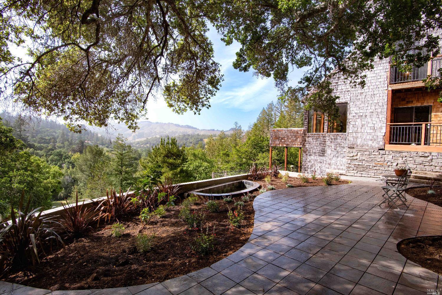 This spacious 3BR/3.5BA retreat sits on a 1 acre lot overlooking the sunny panorama of the San Geronimo valley w/ the Spirit Rock hills on the horizon. You can enjoy this view from the large living room, sunroom & kitchen or from the many decks that offer compelling sunrise & sunset views. The kitchen features useful storage & a walk-in pantry large enough to make Costco proud. The top floor has 1 BR & full bath & a recreation room currently used for playing pool. The bottom floor has 2 huge bedrooms w/ excellent valley views & 2 large full baths. This home offers a 3018 sq ft canvas waiting for you to embellish & improve it w/ your own choice of updated finishes. It was well-built in 1981 by a contractor for his own family. To the left of the home is a well designed sunny patio w/ garden beds & a small fishpond. To the right is a carport for 2 cars & a detached 25X29 ft concrete floor workshop which could accommodate a multitude of uses. The front of the property has a semi circular drive parallel to the road that offers easy parking for an ample number of cars. Nature & wildlife surround this home which is quite private yet close to Marin's best Park, open space preserves, hiking & bike trails, horse stables, Woodacre Market, Fairfax & miles of wild beaches. A rare opportunity!