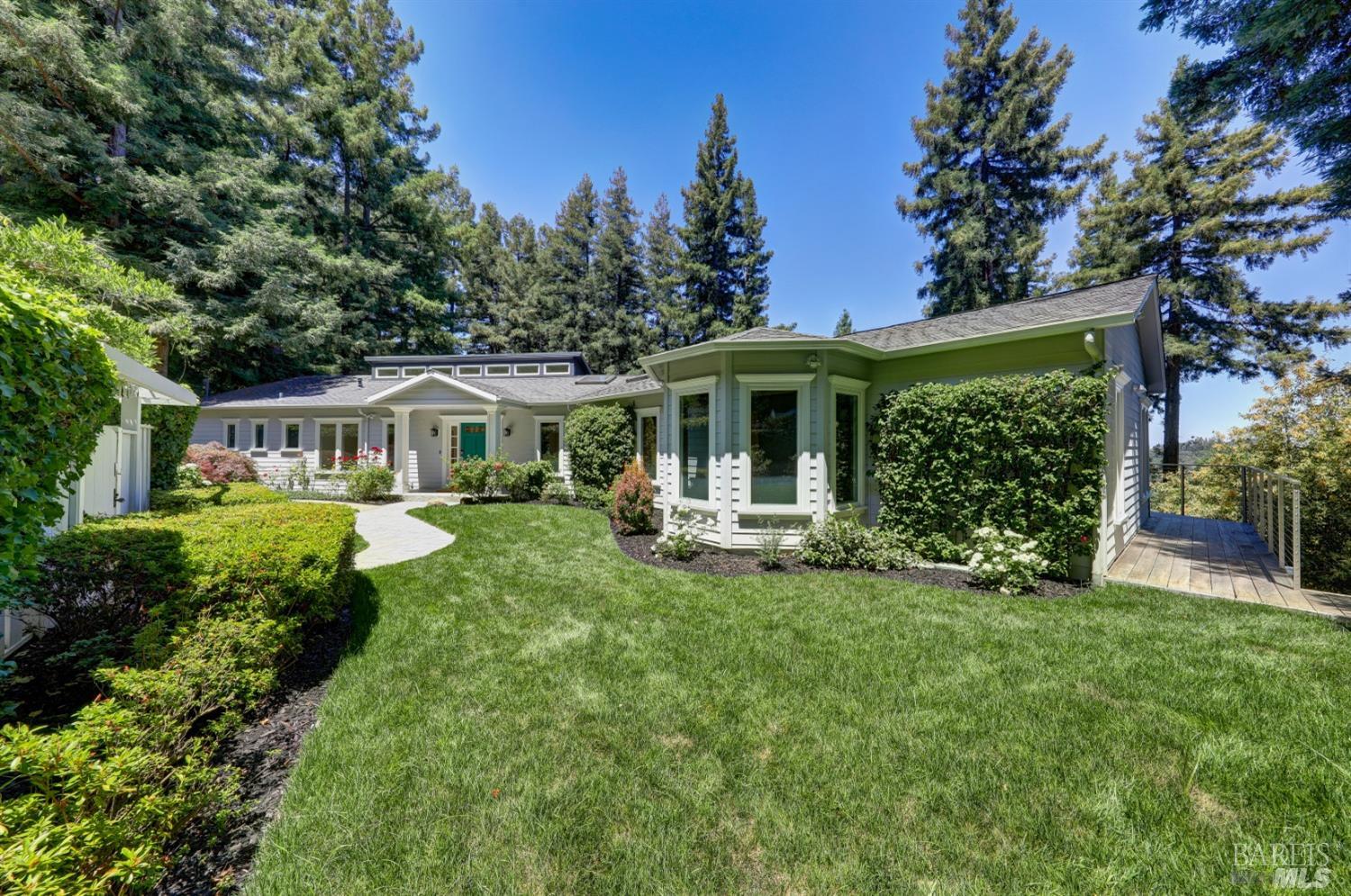 309 Crown Road Kentfield, California This stunning renovated residence is set amongst majestic redwoods in a picturesque setting, offering the utmost in privacy and serenity. Upon entering through the gated front yard you will be captivated by the lush level lawn and beautiful landscape. Grand scale floorplan with room for large families and the avid entertainer. Sophisticated and comfortable living/dining room offers panoramic views and opens to the entertainment deck. The inviting open concept kitchen is ideal for the culinary enthusiast. Main level primary suite and 2nd guest suite. The residence features a library/office with floor-to-ceiling bookshelves and cabinetry, a gym, and family/recreation room offering a multitude of uses. 2 car detached garage. Easy indoor/outdoor living. Situated in the lush hills of Kent Woodlands, the residence offers easy accessibility to the best hiking and biking trails outside your front door and only minutes to Woodland Market and Cafe, Rustic Bakery, Highway 101, the Larkspur ferry terminal and local schools.