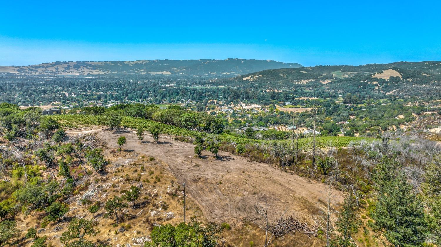 Rare east side Sonoma building parcel with a cleared view building site, almost 360' wine country views. Installed 20+- gpm well and electricity, 3-bedroom vested septic design. The land has a newer 4-stall barn, an arena, hay storage, 3 corrals; also two storage containers currently a tack room and storage. A gated entry accesses the fenced 5.25+- acres with native oaks and a charming seasonal stream. Highly desireble location with a serene country feel just minutes to downtown Sonoma, 1+ hour to San Francisco.