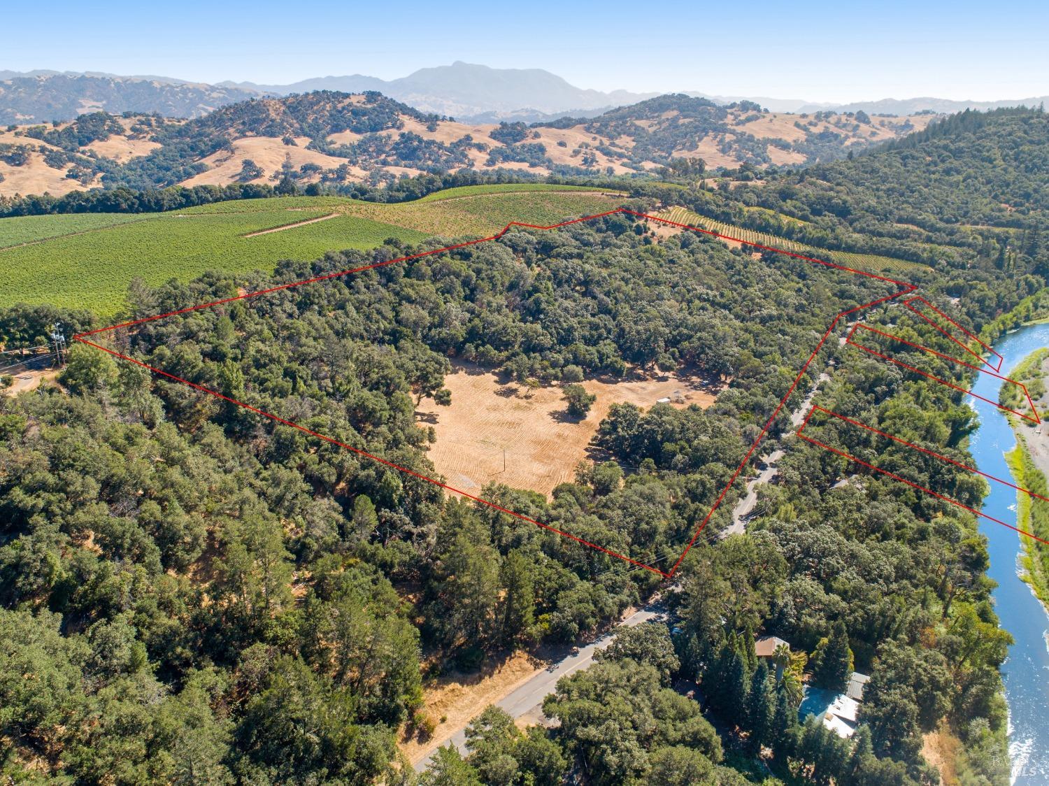 Fabulous home site with commanding views of the Russian River valley and Fitch Mountain. Build your dream home on 25 +/- acres. Includes ownership of three parcels that are points of access to the Russian River. Secluded end of the road privacy. Smooth County paved road to the site. Paved driveway to the main homesite. Open meadows and Oak woodlands. Great southern exposure for solar and a new 14GPM well. Room for hobby vineyard, and additional homesites. Adjacent to world class premium (Silver Oak) vineyards. Less than four miles, Six minutes to the Healdsburg Plaza.