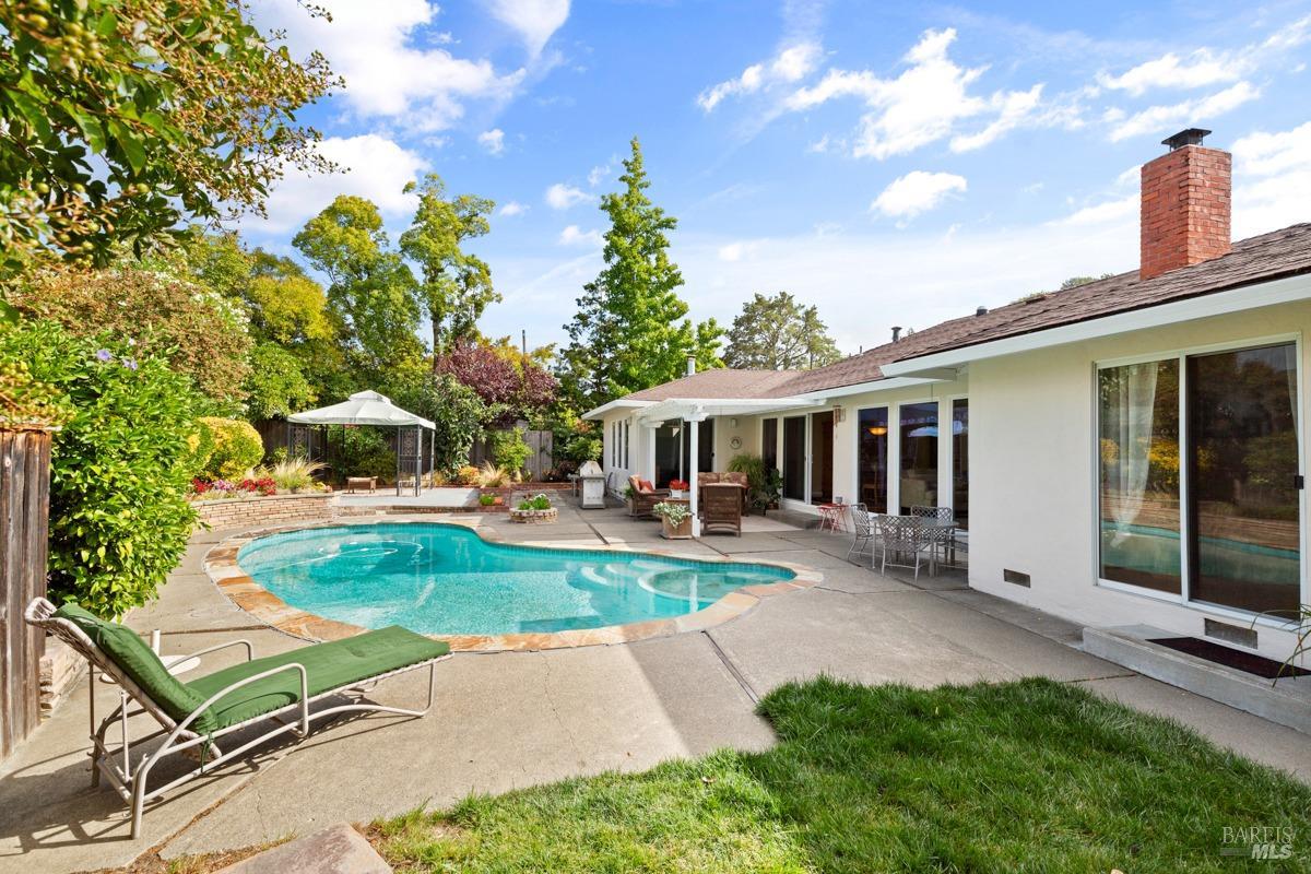 A single-level haven with pool, nestled in idyllic Hillview Gardens in the flats of Larkspur. Bring offers! A true gem, occupying one of the prime lots within this quintessential Leave it to Beaver neighborhood. It is ideally positioned toward the cul-de-sac, on the corner of a quaint court on a xtra wide street. A larger lots, offering the possibility of an ADU or bedroom expansion on side yard, along with an expansive backyard. The epitomie of tranquility and carefree lifestyle. It boasts 3 bedrooms, 2 full bathrooms, and a guest bath, along with an expanded family room. The open layout seamlessly connects the living and dining areas and family room via sliding doors, fostering an effortless flow to the private patio and backyard adorned with lush landscaping, pool and a level lawn. This setting is perfect for hosting BBQs, family gatherings, and entertaining. Two-car attached garage with ample storage.  Hillview, a highly sought-after enclave, is one of Marin's most coveted neighborhoods. a few blocks from Larkspur's vibrant downtown with charming shops, restaurants, etc. Excellent climate and an unbeatable commute location. Easy walking distance of some of Marin's finest parks, world-class hiking/biking trails & award winning schools. NOT in flood zone. A rare find!