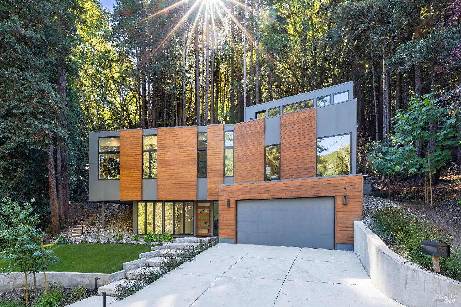 NEW CONSTRUCTION! 5 Tartan Road is nestled in front of a magical intimate and up-lit redwood grove and located around the corner from the coveted Scott Highlands playground, trailheads, and the Mill Valley Golf Course. Phenomenal floorplan. Exterior cedar siding against the cool grey facade brings warmth to a fun and modern facade. Tremendous scale and easy layout. Designer finishes at every turn. Oversized windows and large walls of glass bring the outside in. The open-concept kitchen is straight out of a magazine, boasting high-end appliances and imported Italian cabinetry. Tasteful walnut accents. Ample walk-in pantry and great storage throughout. Large wine display and curated interior design. Two folding walls of glass open to outdoor spaces for playing and al fresco dining. Luxurious primary suite with private balcony. Multi-zone AC and great location. Attached two car garage. Architecture by Richardson Pribuss AIA.