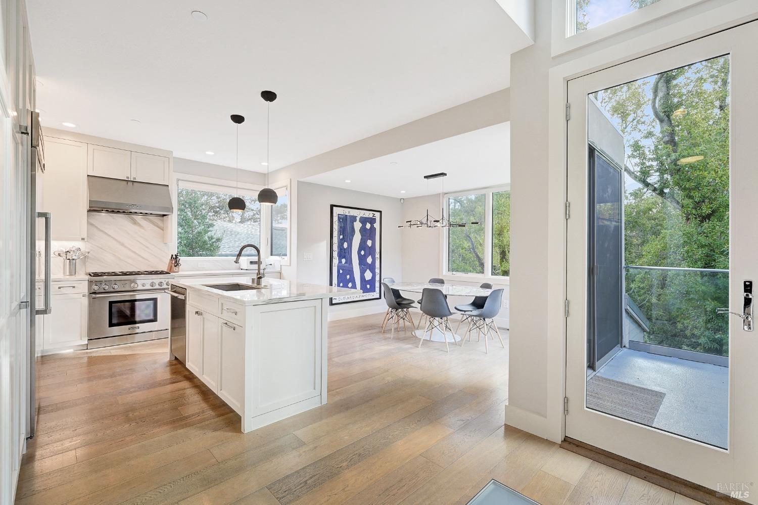 Built in 2013 and designed by architect Jared Polsky, welcome to this modern home in downtown Larkspur. Located above Magnolia Avenue and across the street from Perry's and Equator Coffee, this is one of the most desireable locations in all of Marin County. Looking out at the redwoods, this house feels incredibly private, while being a minute's stroll to everything you would want. Once through the front door, you enter the foyer and are met with a beautiful view of trees through the wall of windows. On this level is the designer kitchen with carrara marble counters and thermador appliances, dining room with doors leading out to the private deck, half bath and living room, perfect for entertaining. Down the stairs on the second level are two guest rooms, a full bathroom and the primary suite, with an incredible walk-in closet and large bathroom with a dual vanity, soaking tub and beautful shower. On the bottom level, there is the fourth bedroom, spacious laundry room, an enormous storage room and a bonus/family room with access to the rear deck and yard, plus your own private staircase leading to Magnolia Ave and all of the restaurants and boutiques that charming Larkspur has to offer.