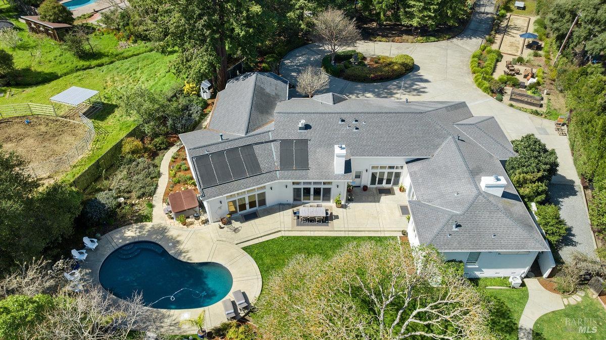 Sunny single-level gated estate on a flat lot in coveted Los Ranchitos in San Rafael w/approx. 4,300+ SqFt, 4 BR/4.5BA + 2 offices. Open & inviting large scale floor plan with a spectacular lot, this home boasts a pool, yard, bocce ball court, chicken coop, redwoods & more, it offers privacy along with benefits of agricultural zoning. The open concept kitchen & great room are the heart of the home w/chef's kitchen & high-end appliances and are open to the Dining & Living rooms -  all with multiple access to the outdoors. The amply sized, luxurious primary suite feels like a resort w/FP, huge walk-in closet, spacious ensuite bath & access to the yard. The other 2 ensuite BRs have updated baths.  Flex 4th BR w/Murphy bed doubles as a media/FamRm.  One of the 2 offices is ensuite to the 4th BA & features a 2nd Murphy bed; addl office/studio is in the rear yard w/half-BA. The gorgeous backyard is the perfect backdrop for fun-filled poolside afternoons & weekend get-togethers. Plenty of parking on the circular driveway + expansive 3-car gar.The ideal location offers secluded country setting, yet mins to hiking, GG Bridge, restaurants, shopping, the train & hwy 101. Award winning Miller Creek schools. THIS is the resort-like home you have been waiting for to enjoy the Marin lifestyle!