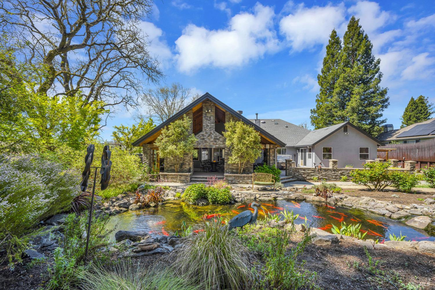This single-level Oasis has the best of all worlds. It's located where Sebastopol & NW Santa Rosa meet Forestville, adjacent to vineyards & the country but with all the conveniences of city water, sewer, solar & a generator back-up.  This home has 2,693+/- sq. ft., 4 large bedrooms, 2.5 baths, & a 3-car garage w/a shop built in 1 garage bay. Its design is open with vaulted ceilings in the main living areas. It has a wonderful outdoor entertainer's room that looks over a gorgeous rear yard with its own Koi Pond, waterfall, walking paths through flowers, wisteria & more, all on a half acre. The spacious primary bedroom has a luxurious stone slab Master Bath with radiant floors & a walk-in closet, along with glass doors to the hot tub outside.  This home offers ample space & privacy on all sides being a corner lot with no neighbors behind it & only one neighbor on one side.  In addition to the entertainer's outdoor room, you'll enjoy wrap-around decks along the side & front corner, all fenced & topped with glass paneling to maintain the country views.  Everything throughout this home & property has been meticulously cared for, so that it can now be offered to you in move-in condition.  Recent upgrades include a new roof & HVAC.  All inspections are available.  This won't last long.