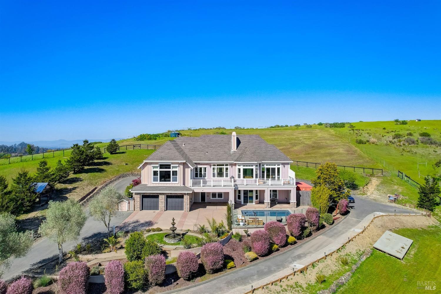 6425 Lovmark Way is a 6+ acre gated equestrian estate boasting panoramic westerly views over Sebastopol's hills towards the ocean and stunning sunsets. A custom barn and arena. Built in 2007, this 4BD/3.5BA 4246 sqft home offers an inviting floor plan illuminated by natural light and elegant finishes/amenities. A saltwater pool as well! The heart of the home is a large family room with cathedral ceiling, stone fp and deck access that flows directly from the kitchen. The stylish and open kitchen features top-tier appliances (Viking and Sub-Zero), a center island w/seating, abundant cabinetry and countertops, and breakfast area. Hardwood floors and 10ft ceilings. The expansive and luxury primary suite w/deck access on the main level presents a sitting area, spa-like BA and walk-in closet with laundry. The lower level houses three additional BDs (one en-suite), a media room, family room with direct access to the pool area, laundry room, storage and bonus room. Other amenities incl: dual zone AC on each floor, central vac, EV charging, upgraded electrical and ducting. Parking for many cars, RV/recreational toys. Plans/prelim inspection in place for a future ADU. A must see for those wanting luxury and privacy, with views! Near top-rated schools and a short drive to 101/DT Sebastopol
