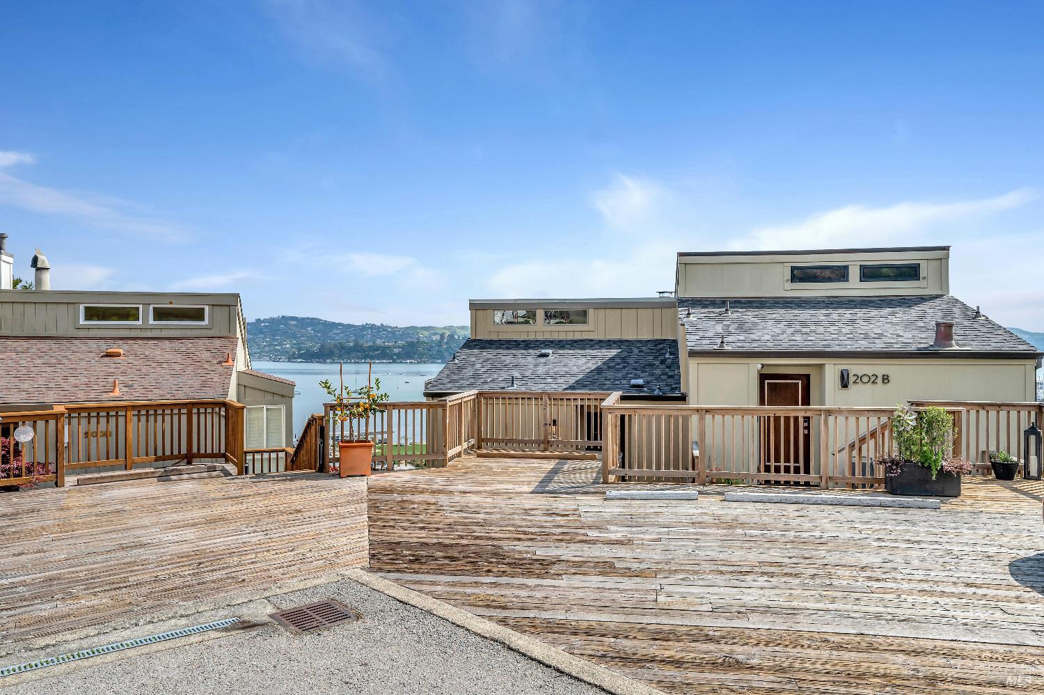 Nestled in the coveted Banana Belt, this charming contemporary home boasts stunning views of the Bay