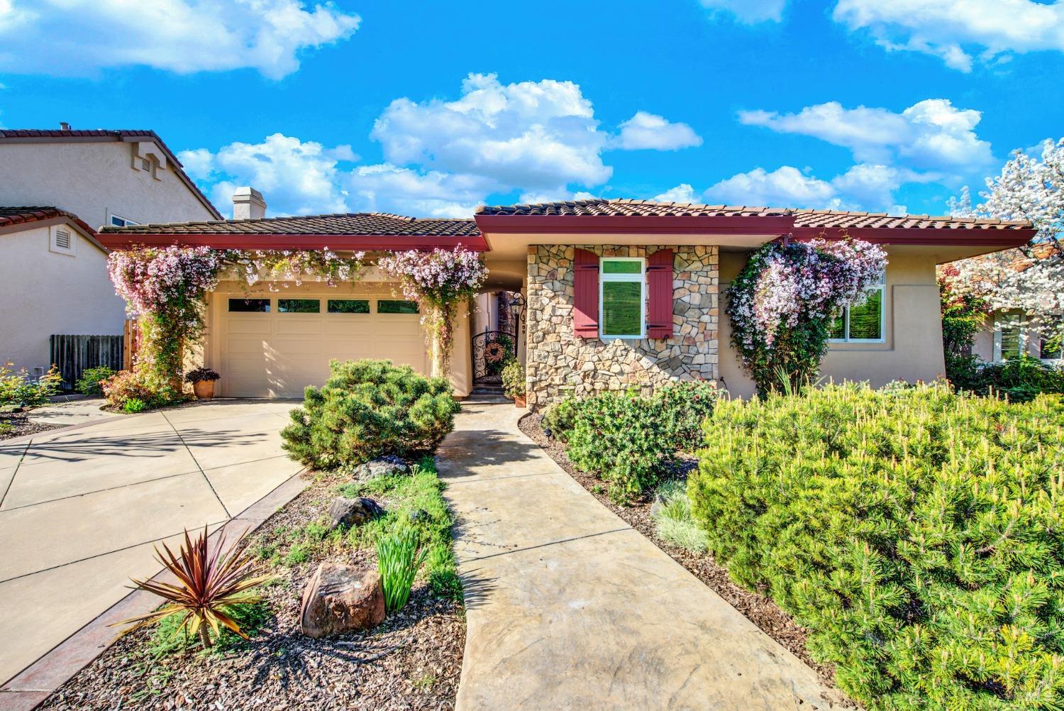 This lovely custom single-story home is nestled in the gated golf course community of Rancho Solano,