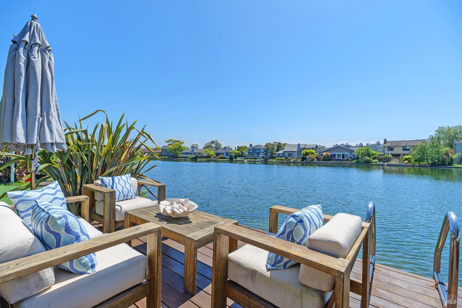 Absolutely stunning remodeled and expanded solar powered paradise, perfectly positioned on one of the most spectacular, sunny, south facing waterfront lots in the entire Marina. Multiple patio doors lead to an outdoor living area, complete with covered patio and full kitchen, built-in spa, outdoor shower, putting green and kayak launch into the lagoon. Relax and gaze at the wide open views of tranquil water, spanning from east to west, capped by photo ready Mt Tam. Quiet setting, yet close enough to walk to schools, parks and shops. Inside is incredible. Natural wood floors, soaring ceilings and a huge open designer kitchen/dining area overlooking the lagoon and hills. Add in the wood burning fireplace and this truly defines a Great Room. Primary Br/Ba is on the main floor, on the water, along with 2 Br's + full bath + powder room. Inside the finished garage is one of TWO laundry areas, plus new furnace, A/C and water heater. Upstairs boasts an enormous family room with built in flat screen and audio components + deck with glass rail, offering views to the north, 1 more Br + a large home office, new full bath and 2nd laundry room. Clean packet on file. NO sloping floors, thanks to extensive permitted foundation and structural improvements. Floating Lily Pad in garage included!