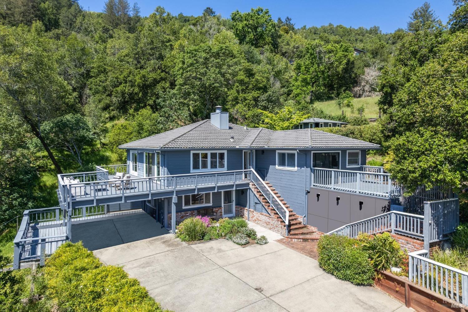 Nestled on nearly TWO acres in the coveted Town of Ross, 11 Woodhaven Road offers a unique opportunity to embrace tranquil living with stunning Mt Tam views. This captivating property has been lovingly maintained by its owners for 67 years, presenting a rare chance to transform it into your dream home. Spanning 2,614 square feet, the residence boasts generous living spaces flooded with natural light, creating an inviting atmosphere throughout. The prime location in Ross ensures proximity to top-rated schools, lush parks, and convenient access to amenities. With the potential for an au-pair or ADU downstairs, the home offers versatile living arrangements to suit various lifestyles. The spacious primary suite features an ensuite bathroom and expansive walk-in closet, providing a private sanctuary for relaxation. Outside, discover a sprawling outdoor oasis with two huge entertainment decks, a wraparound patio, and a sparkling pool offering picturesque views of Mt. Tam, an ideal setting for outdoor gatherings and summer enjoyment. Additional highlights include hardwood flooring, custom built-ins, and a cozy family room with a fireplace. Embrace the quintessential Ross lifestyle and make this exquisite property your own. Located in the highly-regarded Ross School District!