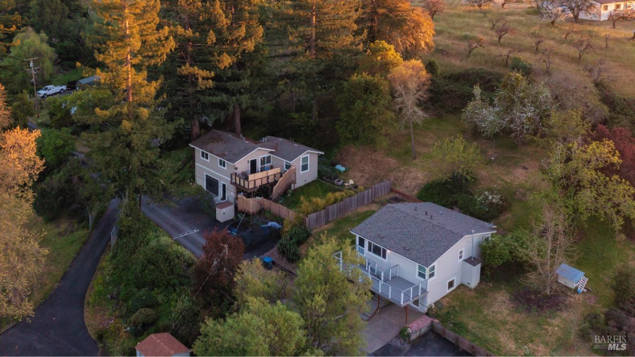 Nestled, amidst redwoods & stunning sunsets sits a serene 2 home retreat. This multi-home set up, tucked off Bodega Hwy, seamlessly blends modern amenities w/the charm of country living. Minutes from town, dining, The Barlow, & the Coast, this hillside oasis offers West ambiance, on 0.7 acres. The two homes, boast 2 beds/2 bath plus den & 2 beds/1 bath plus den, with view decks to soak in the natural beauty. Both homes have undergone upgrades including white cabinets, granite countertops, vinyl/laminate wood-like flooring, and white appliances (gas range). Convenience is key with indoor laundry facilities, attached garage(s) with alternate use options, such as; living space, artist studio, storage, or a workshop. Come explore the expansive grounds, where private gardens create a tranquil atmosphere. Entertain guests or simply unwind in your own slice of paradise, roasting marshmallows around a fire pit, sipping local wine under the stars, or dining al fresco on warm summer evenings. Whether you're an investor, seeking a multi-family opportunity or someone looking to live in one & rent the other, this property presents endless possibilities. Don't miss your chance to create an oasis in Sebastopol, where the beauty of nature meets the comforts of modern living.