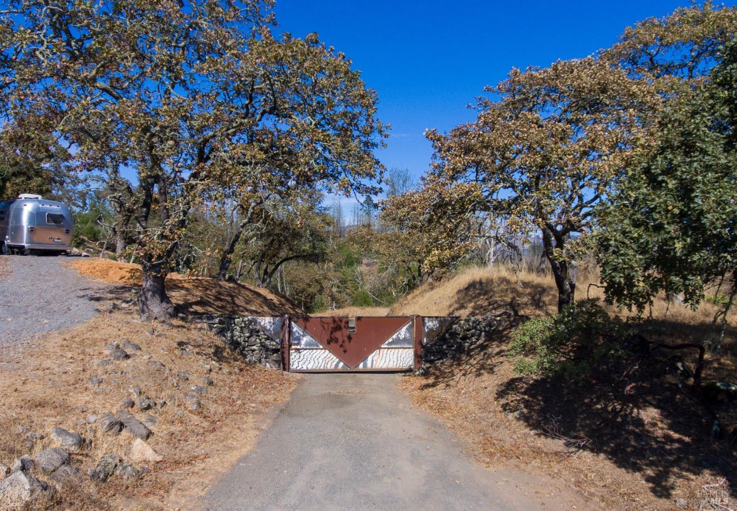 Nestled on Bennett Mountain, this 5.01+/-acre residential parcel offers an exceptional opportunity to create your dream home or legacy estate. Enjoy breathtaking views of Sugar Loaf Ridge State Park and Sonoma Mountain, providing an idyllic backdrop for tranquil living. While impacted by the Sonoma Complex fire in 2017, the parcel has been revitalized with a repaired septic system, ensuring it's ready for your vision. The Bennett Ridge community is almost completely rebuilt and is a fire wise neighborhood. The property benefits from a community mutual water system, and electrical power has been stubbed to the parcel, simplifying the building process. With ample usable land, you can explore various possibilities, whether establishing a peaceful retreat, raising animals, or starting a hobby vineyard. The parcel is adjacent to Annadel State Park, granting easy access to miles of hiking and outdoor adventures. The paved driveway and gated entrance add privacy and security, making this parcel a true sanctuary. Imagine waking up to stunning vistas and the sounds of nature, all while being conveniently located to nearby amazing wineries, restaurants and all other amenities. This is more than just land; it's a canvas for your dreams in one of California's most picturesque regions.