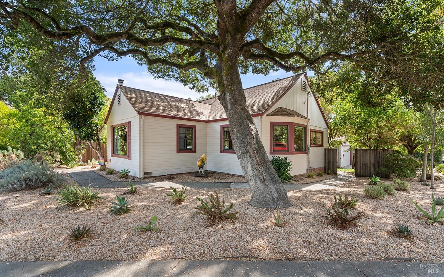 Charming single level bungalow in a desirable neighborhood of intown Sebastopol. Set on a corner lot of a quiet street with detached 2 car garage. Landscaped yard with beautiful oak tree and complete privacy in back with deck for outdoor living. Spacious floor plan features period details: coved ceiling, hardwood floors, built in cabinetry, and picture windows to let in the natural light. Woodstove with hearth. Large laundry/exercise room or possible office. Recent updates include central heating, fencing, EV charger, quartz counters, entry door and more. Walking distance to fine restaurants and all that Sebastopol has to offer.