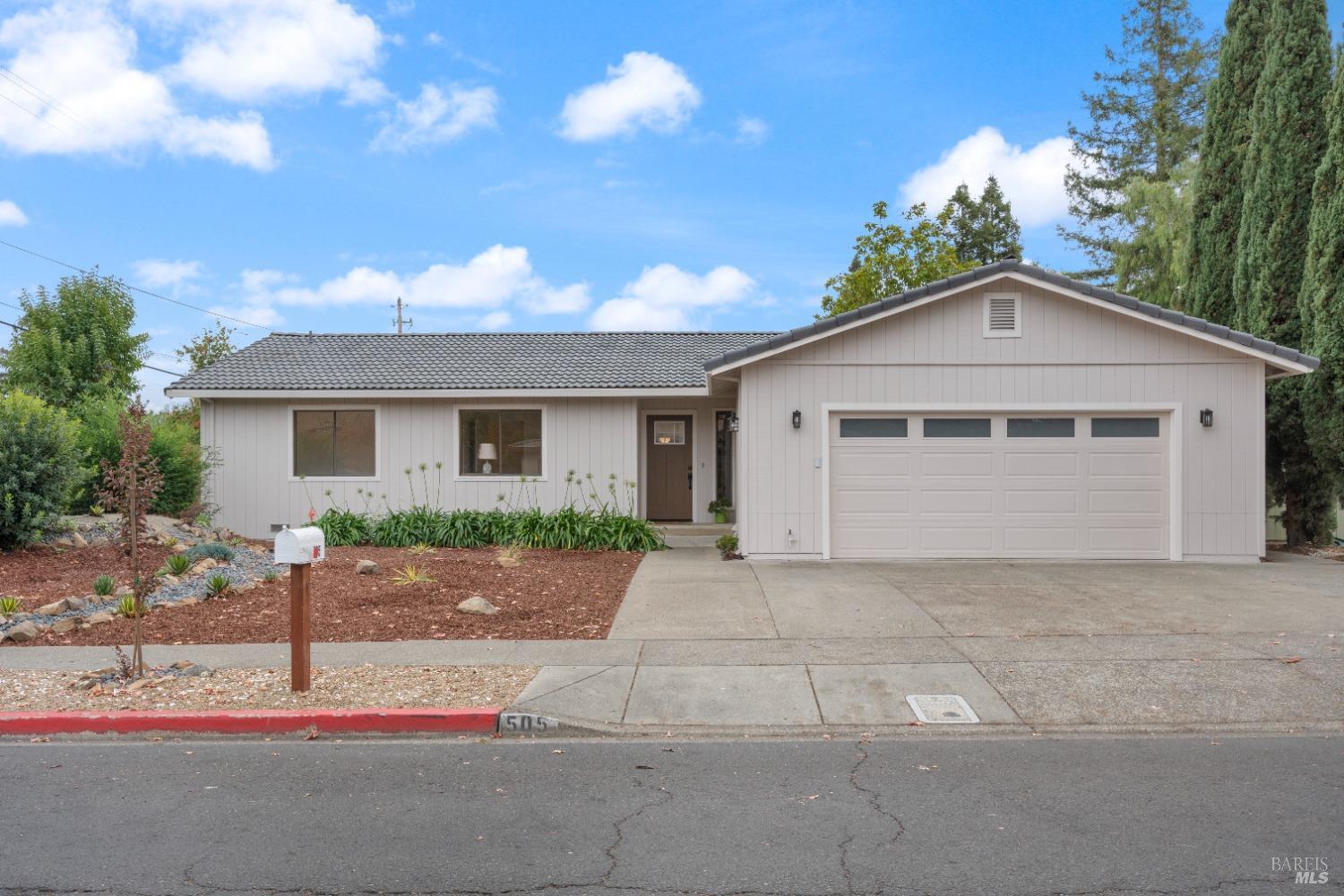 Nestled in the heart of Sonoma Wine Country, this beautifully updated home combines modern comfort with timeless charm. Inside, newly installed light wood laminate flooring flows throughout an open and inviting layout, featuring a cozy living room with a wood-burning fireplace and a dining area that opens to a serene backyard. The kitchen is equipped with stainless steel appliances and a stylish breakfast bar, ideal for entertaining. Outside, the private backyard offers a concrete patio for alfresco dining, fully fenced for privacy. Located near the open space preserve, historic General Vallejo's Home, and the Sonoma Bike Path connecting to the vibrant Sonoma Plaza, this property offers convenient access to world-class dining, shopping, and events. Additional features include a two-car garage, a Nest smart thermostat, and proximity to all that Sonoma has to offer, with San Francisco just an hour away.