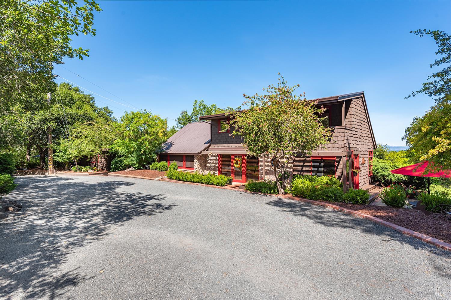 Welcome to this exceptional multi-residence estate on 2.85 acres in Sebastopol's scenic countryside with panoramic views of the valley, hills, and redwood-studded ridges. This rare offering includes a beautifully updated main home plus three detached residences, ideal for a family compound, rental income, or retreat. Each residence is privately situated among mature trees, lush landscaping, and garden paths. The main home features rustic architectural elements, open beam ceilings, formal dining, a central kitchen with island and pantry, and a light-filled living room with access to multiple outdoor spaces. The primary suite offers a sitting area, private balcony, and vintage-tiled bath. A detached 1 bed, 1 bath guest house with a full kitchen provides added flexibility, and two additional units expand the potential. Outdoor highlights include multiple decks, patios, garden beds, seasonal stream frontage, and open land with room for planting or orchard use. Minutes to downtown Sebastopol and the Russian River. Tax roll is incorrect. By appointment only.