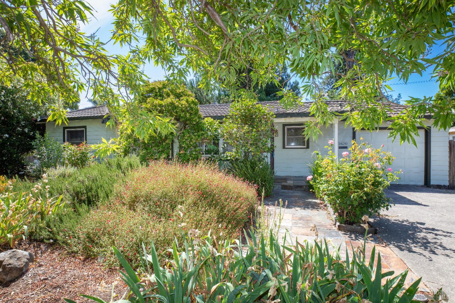 2620 Sonoma Avenue Santa Rosa, California This Montgomery Village charmer is located close to restaurants, shopping, parks and great schools. It is situated on a 6500 sf lot about a quarter block from Montgomery Village. It is beautifully landscaped front and rear. There is an enchanting zen sitting area with mature trees and raised garden beds in the rear and low maintenance flowering landscape in the front. This home has two bedrooms, a previously updated kitchen and bath and a drive through garage with a small garage/shop in the rear.