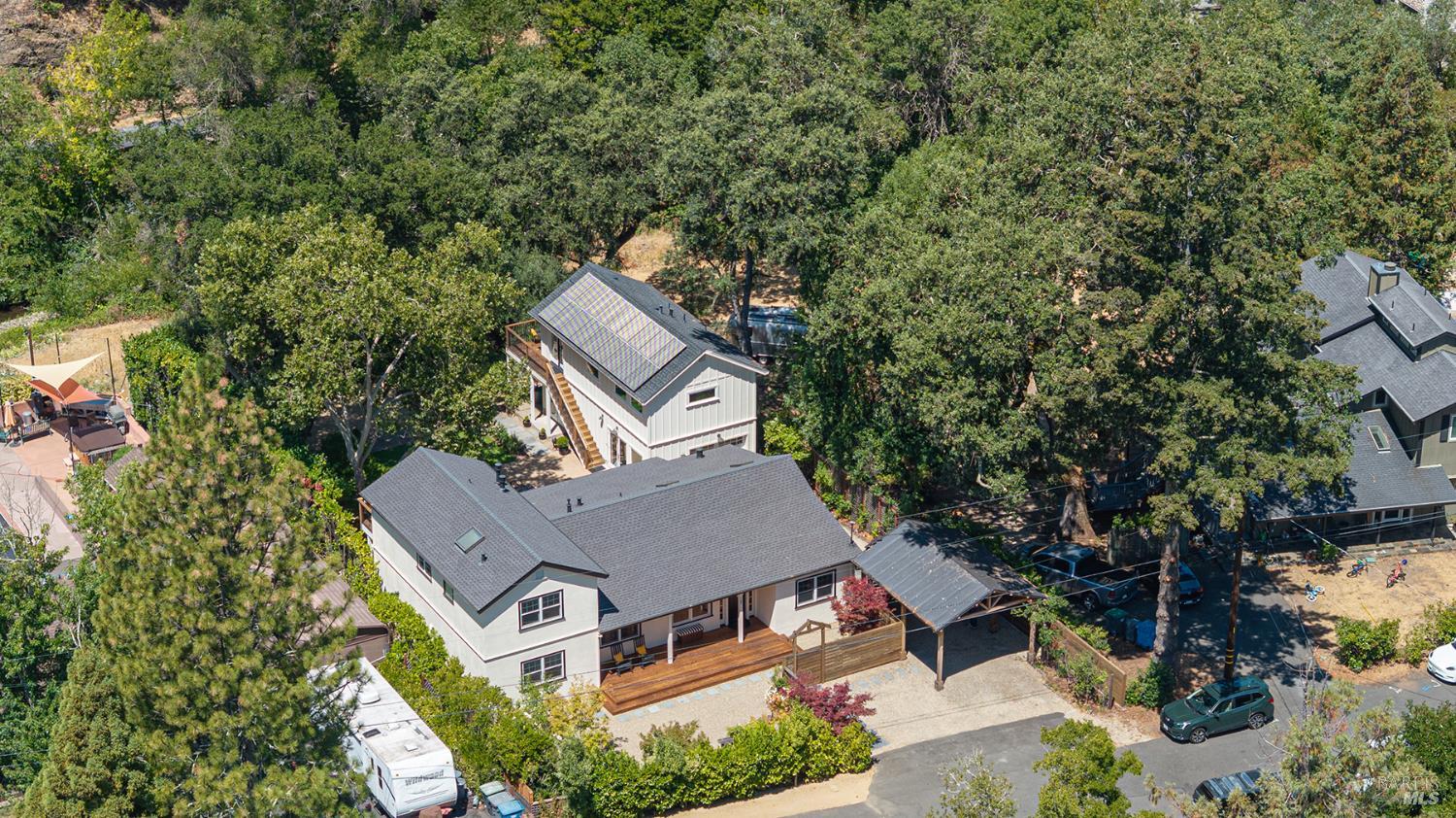 Must see, tastefully updated main home with separate carriage house on nearly one third acre lot with oak covered ridge line view in super charming Glen Ellen Village.  Down a private land and situated along the Calabazas Creek with green screen privacy, the 4-bed/3-bath (two en suite, one upstairs for tree house feel or one downstairs with single level advantages) main house features an open kitchen with large Carrara marble island, farmhouse sink, stainless appliances, cherry hardwood floors, pantry, and skylights that bathe the rooms in gentle light. Bathrooms with a lux feel of walk-in tiled showers, lighted mirrors and bidets. Primary bedroom fireplace, newer heat pump a/c plus mini-split upstairs. Owner owned solar with back up battery. Large front and backyard decks look out at mature oak, sycamore, Japanese maples, plum and apple trees. Enjoy indoor/outdoor lifestyle with games of Petanque in the backyard. Alternately, if you want there is room for pool. Glen Ellen features multiple destination restaurants, winding creeks, an iconic bridge over which the annual Jack London Yacht Race is launched.  It is dialed in, all here and waiting for you.