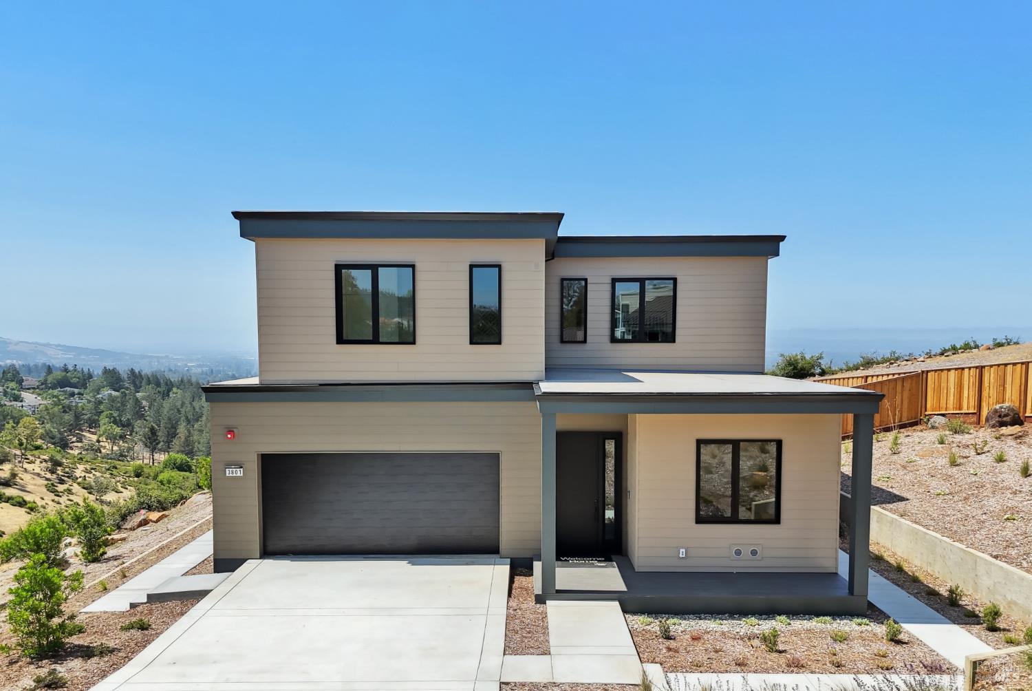 This newly built Veev home in Santa Rosa's desirable Fountaingrove neighborhood combines modern design with cutting-edge technology for a seamless living experience. Located just minutes from parks, the exclusive Fountaingrove Club, Paradise Ridge Winery, and premier dining and shopping, it offers both convenience and luxury. Designed for long-term durability and minimal maintenance, the home features eco-friendly High-Performance Surface (HPS) walls, European style tilt-and-turn windows, and linear, dimmable LED lighting. Smart home enhancements include room specific HVAC control, solar panels, a Tesla Powerwall, and wiring for two EV chargers, ensuring exceptional energy efficiency. The gourmet kitchen is a chef's dream, equipped with sleek cabinetry, a wine fridge, a coffee bar/pantry, and a spacious solid-surface island. The open floor plan flows effortlessly between the kitchen, great room, and outdoor spaces, perfect for entertaining. Upstairs, a cozy family room provides additional space to unwind, while the spacious primary suite offers a private retreat. Thoughtfully designed with precision engineering, this home is built to inspire, endure, and enhance everyday living. Photos may not depict actual home being sold. Photos may be of model home.