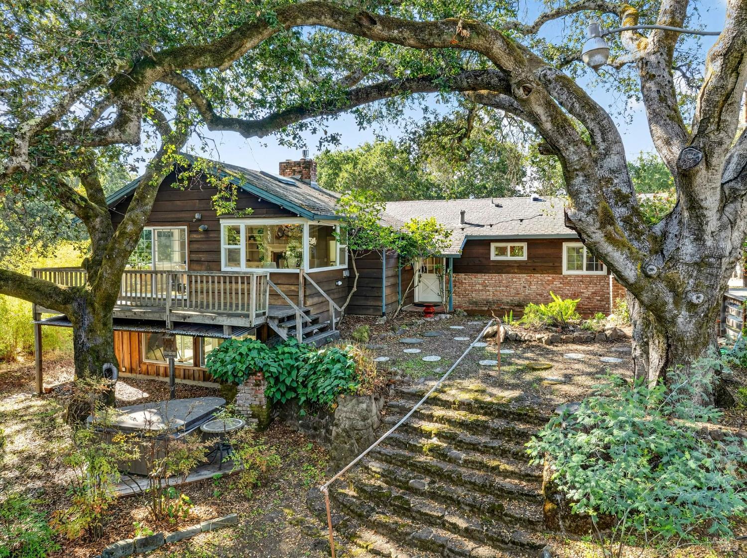 4894  Wagon Wheel Lane  Santa Rosa, California Your country dream home so close to town in highly desired Rincon Valley school district! 2093sf on 3/4 acre offers both bedrooms and full bathrooms, kitchen, office and laundry on a single level! En suite bath and office enjoy luxurious radiant floor heating on stylish tile. The original kitchen has been completely reconfigured with all stainless appliances, six burner stove, stone countertops, central island with stool height counter for in-kitchen dining. The family room includes soaring cathedral ceilings, skylight, fireplace, and windows all around with views of your majestic oak and winter creek. Step out onto the attached deck and you are overlooking the shaded glade. Step through your redwood trees on the other side of your creek to the completely fenced livestock enclosure with goat barn and two stall sheep shelter with hay storage and even a chicken coop! The secret treasure may be the bonus room downstairs that even features its own wood burning fireplace. High efficiency furnace, ductless heat/cooling, on demand water heater, washer and dryer included, plus solar tubes filling the home with natural light throughout. There hasn't been another home available on this private lane in nine years, don't miss out!